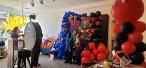 This picture shows several people dressed in Halloween Costumes having fun using the Magic Photo Mirror Booth by GBF Bespoke Balloons and event services.
