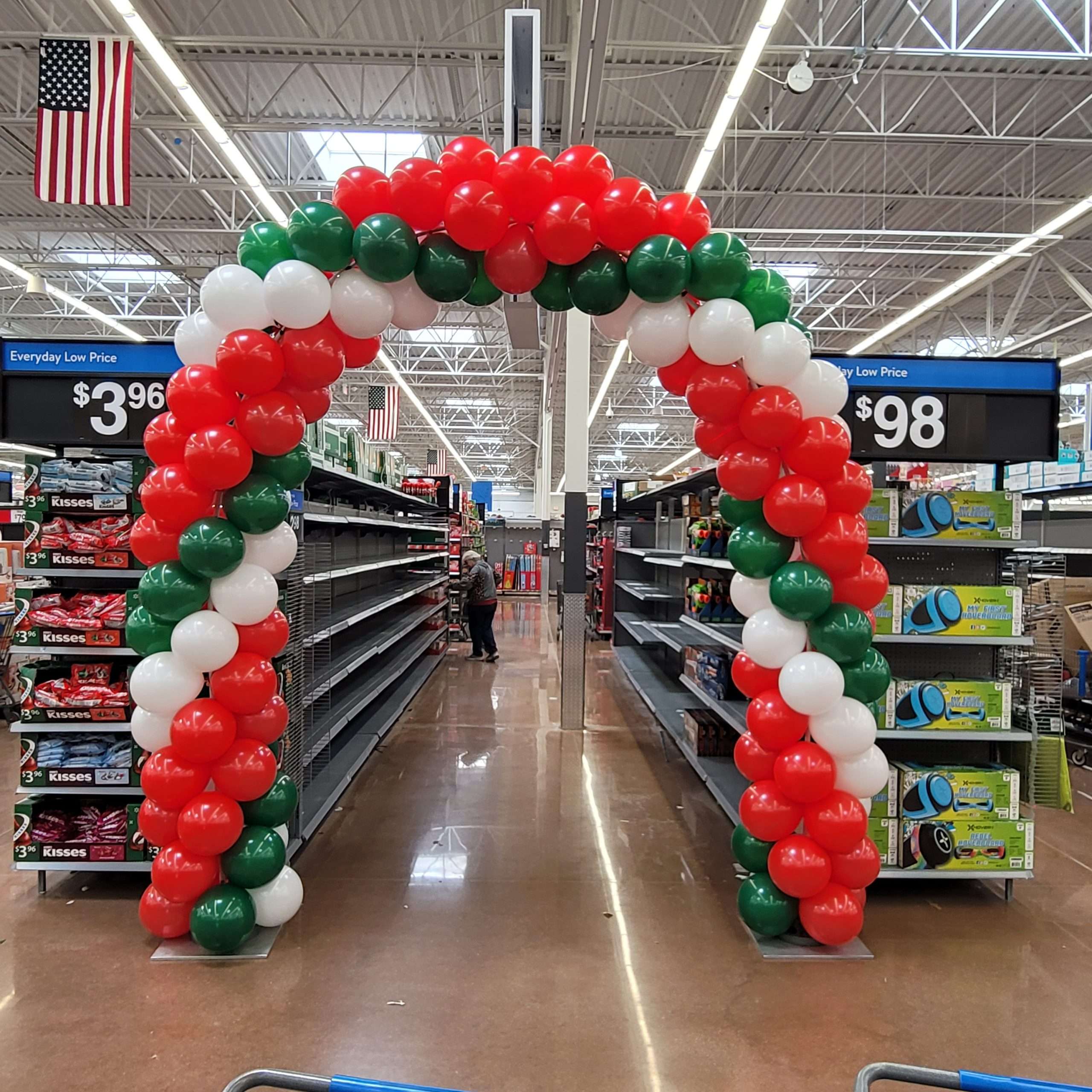 Christmas-themed balloon arch in red, white, and green at Walmart in Germantown, Wisconsin.