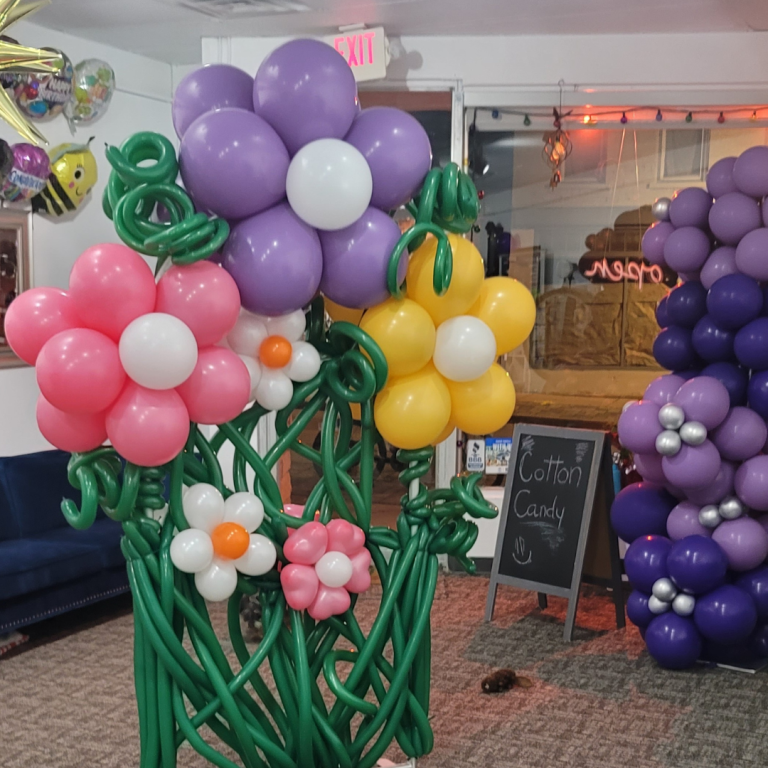 Bringing a touch of whimsy to our boutique with this vibrant balloon flower backdrop!
