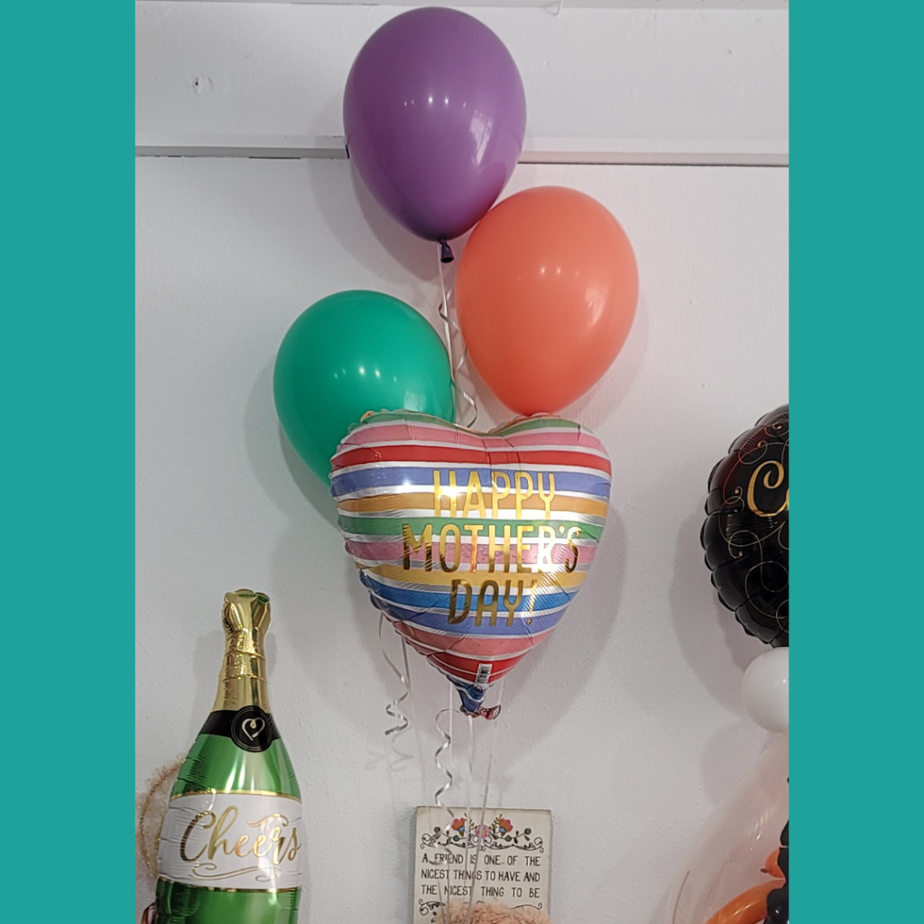 A joyful helium balloon bouquet with three colorful latex balloons and a heart-shaped 'Happy Mother's Day' mylar balloon, a simple but festive celebration.