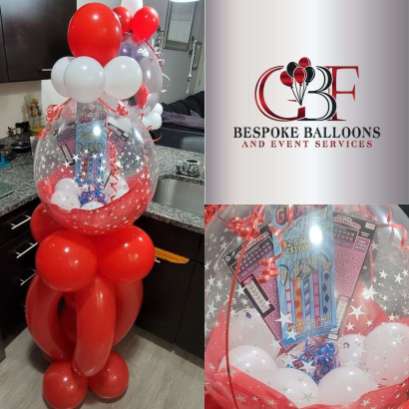 This is a product photograph of a Winner's Circle Oversized Stuffed Balloon made by GBF Bespoke Balloons and Event Services, This has the logo for Bespoke Balloons and oversized stuffed balloon filled with Wisconsin lottery tickets. A unique and fun way to gift lottery tickets.